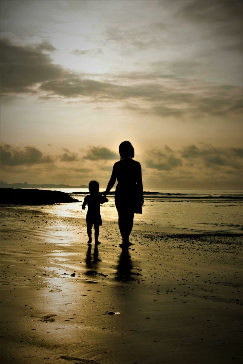 mother and child walking on a beach